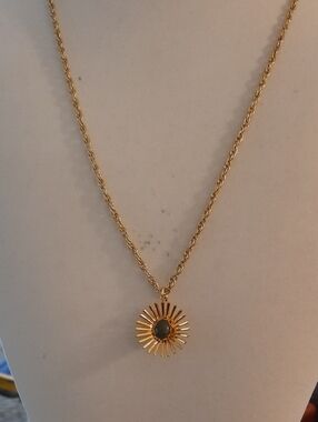 Gold Sunburst Pendant Necklace with Dark Stone